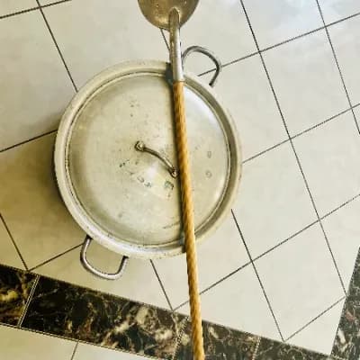 Large aluminium cooking pot with lid and wooden skimmer